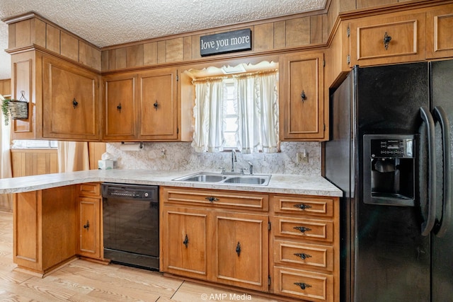 1201 New Hope Rd, Stamford, TX 79553 - kitchen featuring black appliances, a sink, brown cabinetry, and a textured ceiling