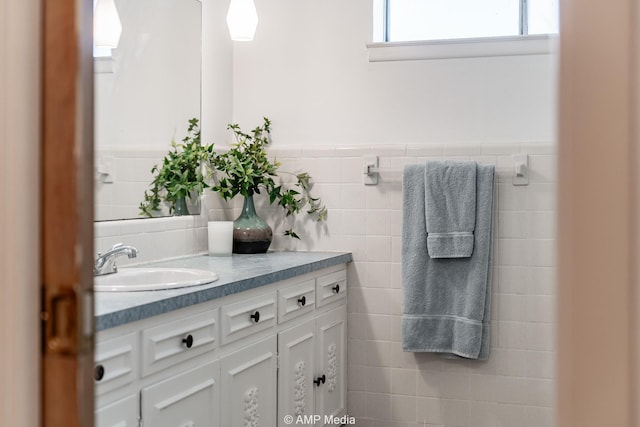 1201 New Hope Rd, Stamford, TX 79553 - bathroom with tile walls, vanity, and wainscoting