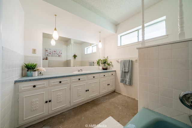 1201 New Hope Rd, Stamford, TX 79553 - full bath featuring tile walls, concrete flooring, vanity, a bath, and wainscoting