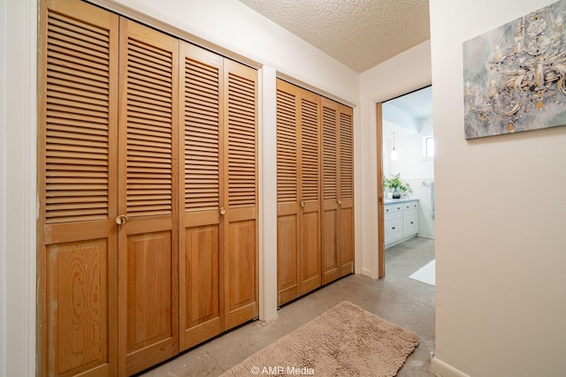 1201 New Hope Rd, Stamford, TX 79553 - hallway featuring concrete floors and a textured ceiling