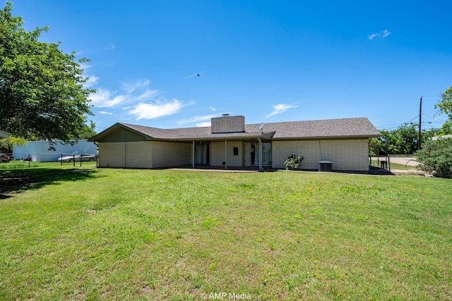 1201 New Hope Rd, Stamford, TX 79553 - back of house featuring a chimney and brick siding