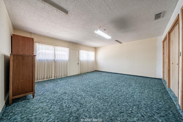 1201 New Hope Rd, Stamford, TX 79553 - unfurnished bedroom featuring carpet and a textured ceiling