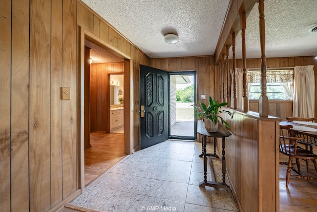 1201 New Hope Rd, Stamford, TX 79553 - entryway with wood walls and a textured ceiling