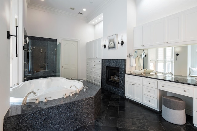 12229 Pecan Forest Dr, Dallas, TX 75230 - full bathroom featuring a glass covered fireplace, a jetted tub, a stall shower, ornamental molding, and vanity