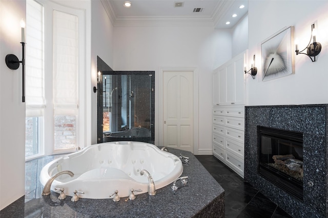 12229 Pecan Forest Dr, Dallas, TX 75230 - full bath with a whirlpool tub, crown molding, recessed lighting, and a tiled fireplace