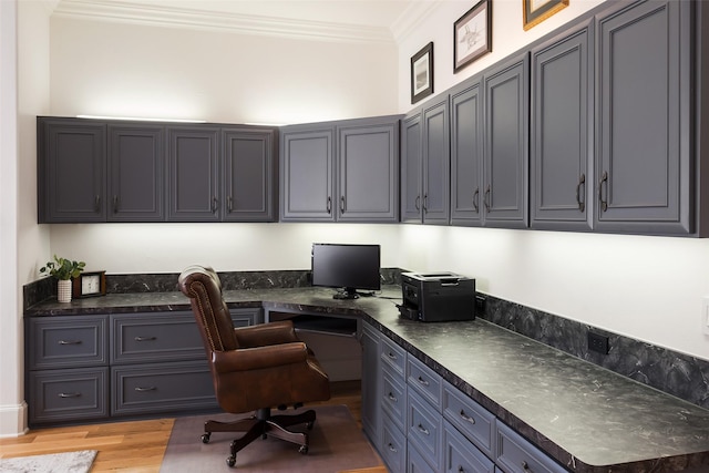 12229 Pecan Forest Dr, Dallas, TX 75230 - office area featuring built in desk, crown molding, and light wood-style flooring