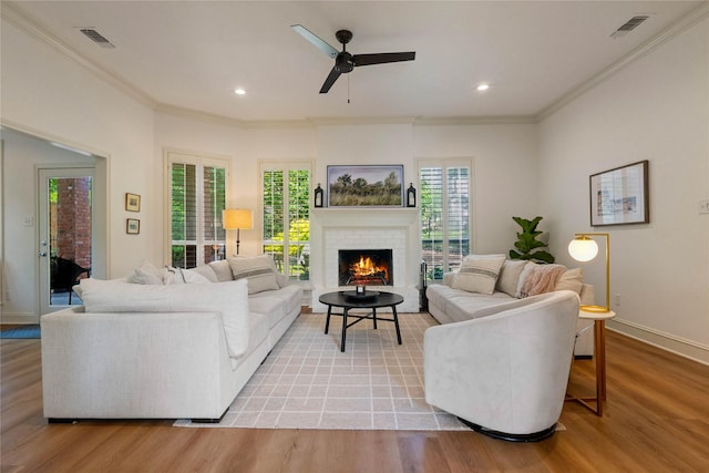 109 Sceptre Dr, Rockwall, TX 75032 - living area featuring plenty of natural light, ornamental molding, light wood-style flooring, a brick fireplace, and recessed lighting