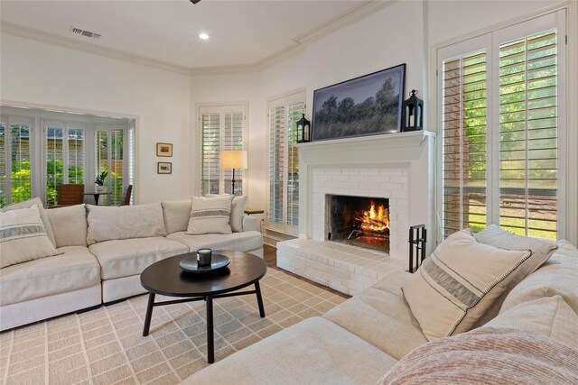 living room featuring a brick fireplace, ornamental molding, and recessed lighting