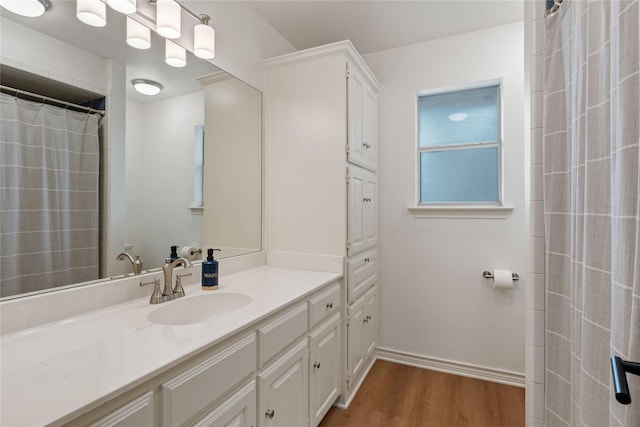 full bath featuring wood finished floors, vanity, and a shower with curtain