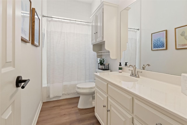 full bath with wood finished floors, toilet, vanity, and shower / tub combo with curtain