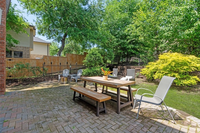 view of patio featuring fence and outdoor dining area