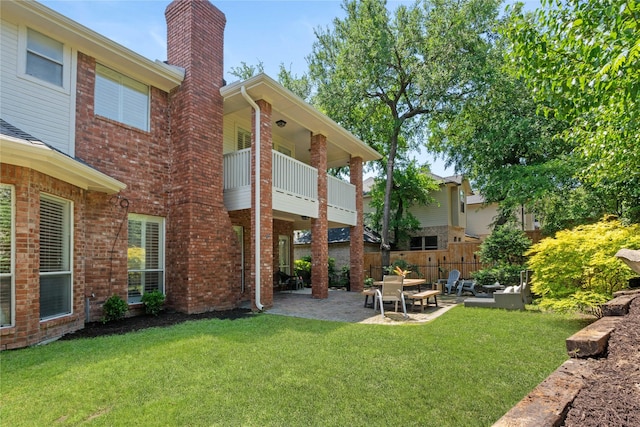 view of yard featuring a patio area and a balcony