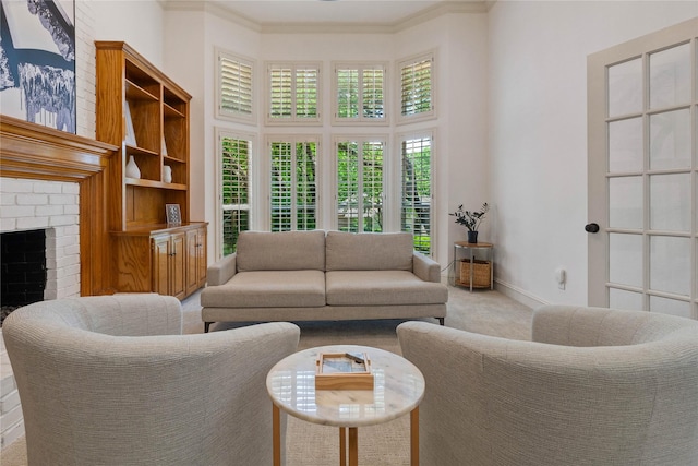 carpeted living area with a towering ceiling, a fireplace, ornamental molding, and baseboards