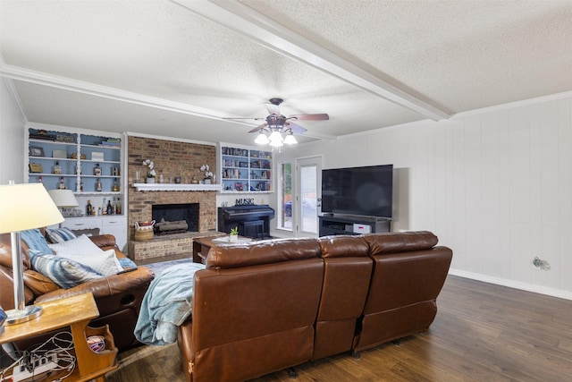 1317 Kingsbridge Dr, Garland, TX 75040 - living room featuring a textured ceiling, ceiling fan, wood finished floors, a brick fireplace, and baseboards