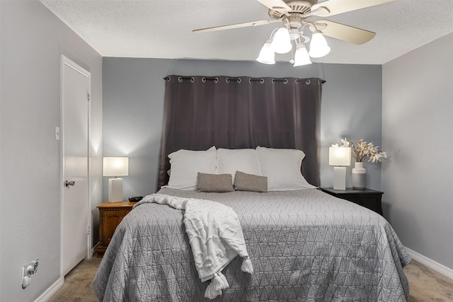 1317 Kingsbridge Dr, Garland, TX 75040 - carpeted bedroom with baseboards, a textured ceiling, and a ceiling fan