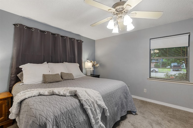 1317 Kingsbridge Dr, Garland, TX 75040 - bedroom with carpet, baseboards, ceiling fan, and a textured ceiling