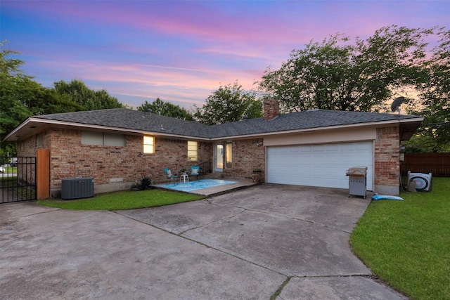 1317 Kingsbridge Dr, Garland, TX 75040 - view of front of house featuring brick siding, central air condition unit, driveway, and a garage