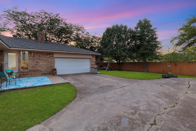 1317 Kingsbridge Dr, Garland, TX 75040 - view of home's exterior with concrete driveway, brick siding, a garage, a chimney, and a shingled roof