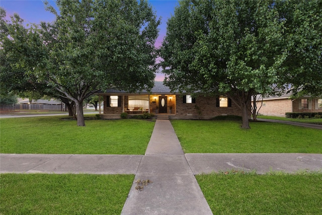 1317 Kingsbridge Dr, Garland, TX 75040 - ranch-style home featuring a front lawn and brick siding