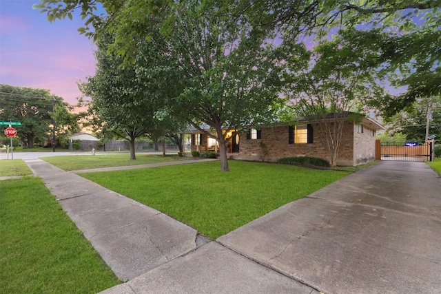 1317 Kingsbridge Dr, Garland, TX 75040 - single story home with a yard, a gate, brick siding, and driveway