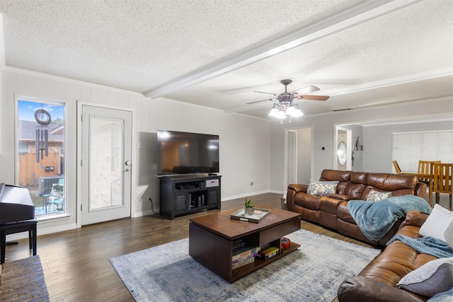 1317 Kingsbridge Dr, Garland, TX 75040 - living room featuring a textured ceiling, ceiling fan, wood finished floors, crown molding, and beamed ceiling