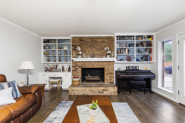 1317 Kingsbridge Dr, Garland, TX 75040 - living room with ornamental molding, wood finished floors, built in shelves, and a fireplace