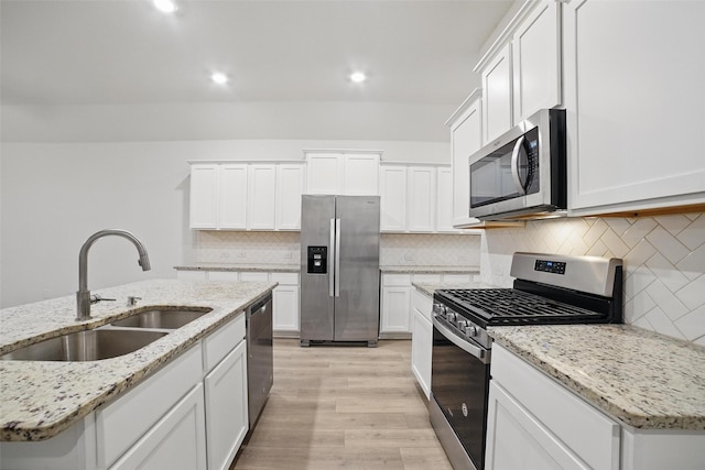 505 Pleasant Hill Ln, Fate, TX 75189 - kitchen with appliances with stainless steel finishes, a sink, light wood-style floors, decorative backsplash, and recessed lighting