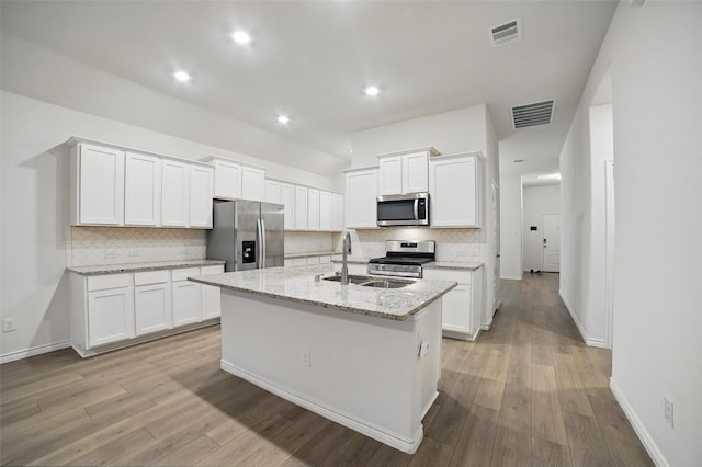 505 Pleasant Hill Ln, Fate, TX 75189 - kitchen with stainless steel appliances, a sink, decorative backsplash, white cabinets, and recessed lighting