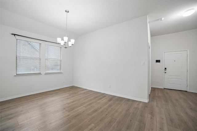 505 Pleasant Hill Ln, Fate, TX 75189 - spare room featuring a chandelier, wood finished floors, and baseboards