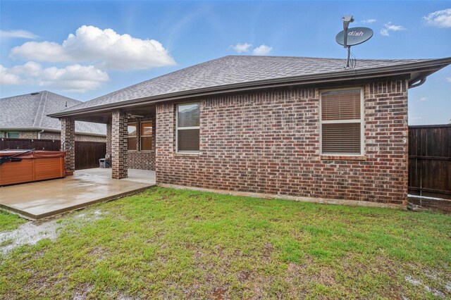 505 Pleasant Hill Ln, Fate, TX 75189 - back of property featuring a hot tub, a patio, brick siding, and a shingled roof