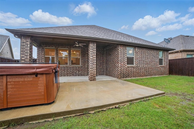 505 Pleasant Hill Ln, Fate, TX 75189 - back of house with a hot tub, a ceiling fan, brick siding, a patio, and roof with shingles