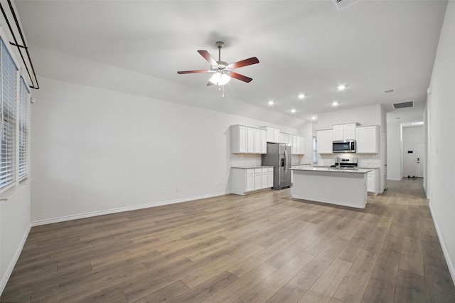 505 Pleasant Hill Ln, Fate, TX 75189 - kitchen with appliances with stainless steel finishes, open floor plan, a ceiling fan, light countertops, and recessed lighting
