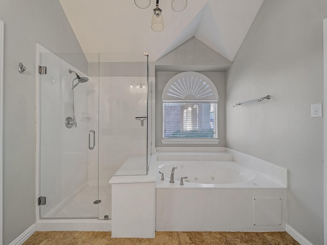 full bathroom featuring a stall shower, vaulted ceiling, a whirlpool tub, and baseboards