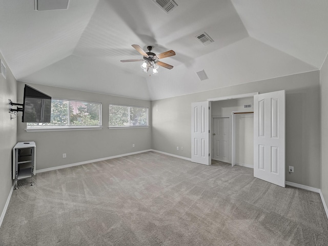 unfurnished bedroom with lofted ceiling, carpet, ceiling fan, and baseboards
