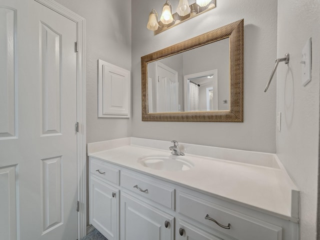 bathroom with vanity and a chandelier