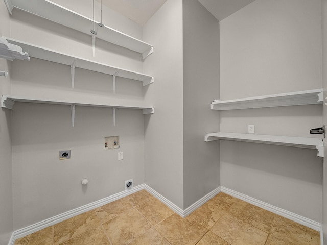 laundry area featuring hookup for an electric dryer, washer hookup, baseboards, and hookup for a gas dryer