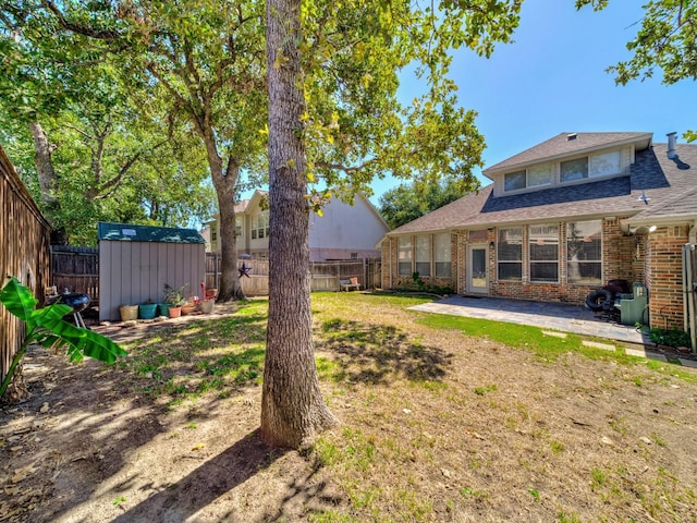 view of yard with a patio area, a shed, and an outdoor structure