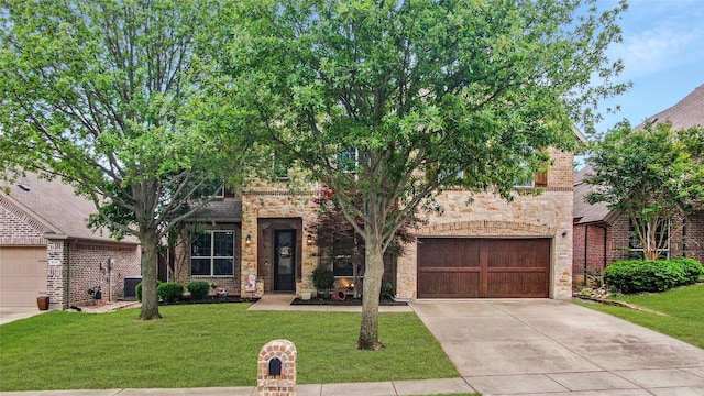 8205 Saint Clair Dr, Mckinney, TX 75071 - view of front of house featuring concrete driveway, a front lawn, and stone siding