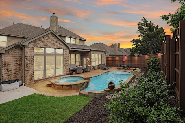 8205 Saint Clair Dr, Mckinney, TX 75071 - pool at dusk featuring a fenced backyard, a patio area, and a pool with connected hot tub