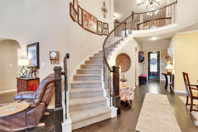 8205 Saint Clair Dr, Mckinney, TX 75071 - entryway with arched walkways, a towering ceiling, dark wood finished floors, stairs, and a chandelier
