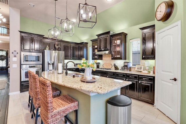 8205 Saint Clair Dr, Mckinney, TX 75071 - kitchen with stainless steel appliances, a sink, a chandelier, tasteful backsplash, and a kitchen breakfast bar