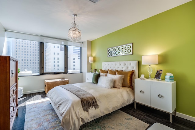 1200 Main St Unit 809, Dallas, TX 75202 - bedroom with a chandelier, wood finished floors, and baseboards
