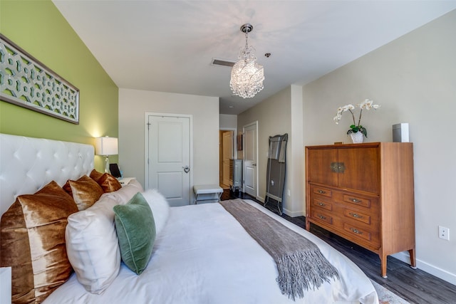 1200 Main St Unit 809, Dallas, TX 75202 - bedroom with baseboards, wood finished floors, and a chandelier