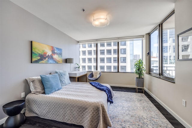 1200 Main St Unit 809, Dallas, TX 75202 - bedroom featuring dark wood-style flooring and baseboards