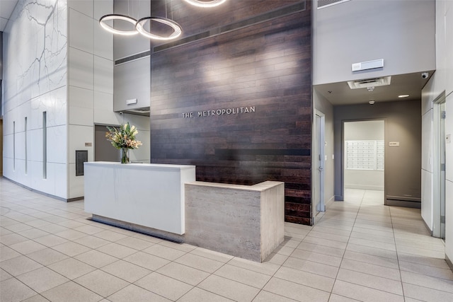 1200 Main St Unit 809, Dallas, TX 75202 - welcome area featuring a towering ceiling, a surveillance system, and wooden walls