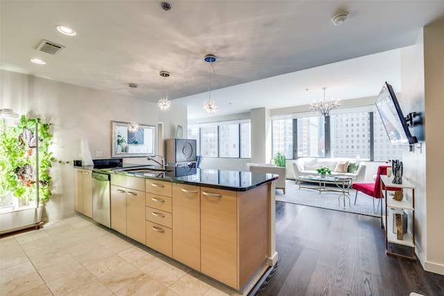 1200 Main St Unit 809, Dallas, TX 75202 - kitchen featuring a chandelier, stainless steel dishwasher, a sink, a peninsula, and dark stone counters