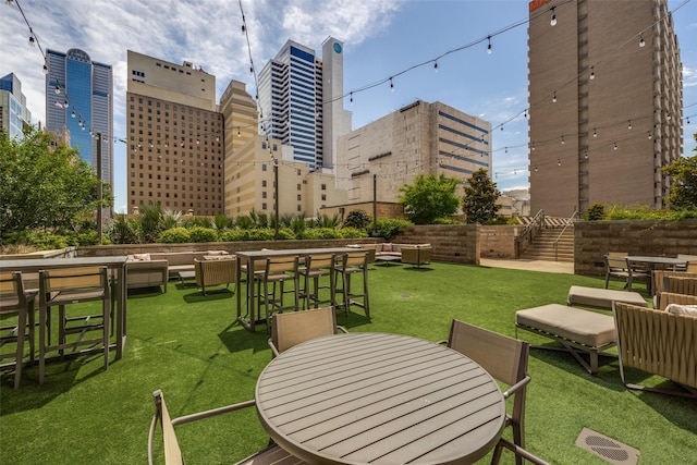 1200 Main St Unit 809, Dallas, TX 75202 - view of community featuring outdoor dining area, a yard, and stairway
