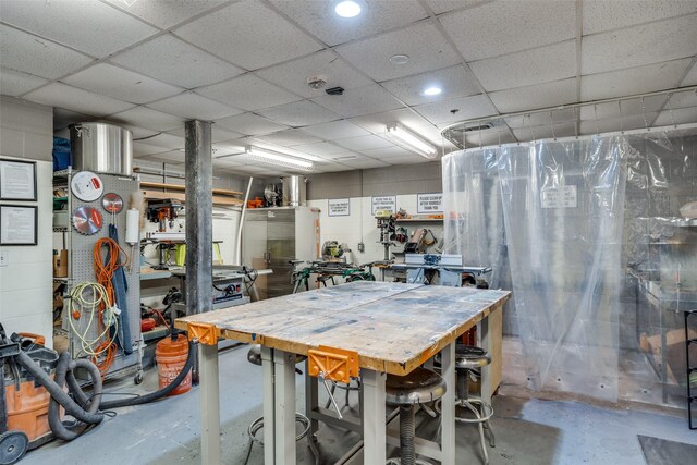 1200 Main St Unit 809, Dallas, TX 75202 - dining room with unfinished concrete floors, a workshop area, and a paneled ceiling
