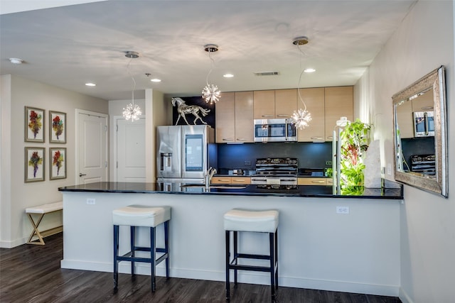 1200 Main St Unit 809, Dallas, TX 75202 - kitchen featuring stainless steel appliances, dark countertops, a sink, a breakfast bar, and dark wood-style floors