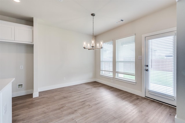 6725 Palmdale Dr, Fort Worth, TX 76123 - unfurnished dining area with a chandelier, light wood-style floors, and baseboards